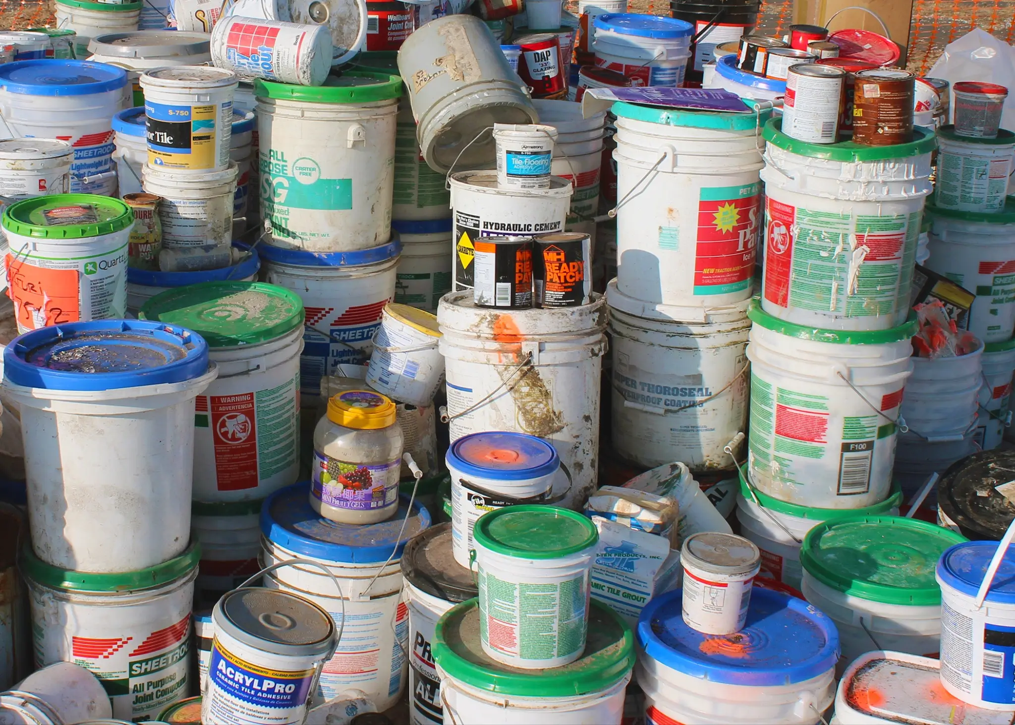 A selection of common household hazardous waste items, which can quickly increase your junk removal costs in Illinois.