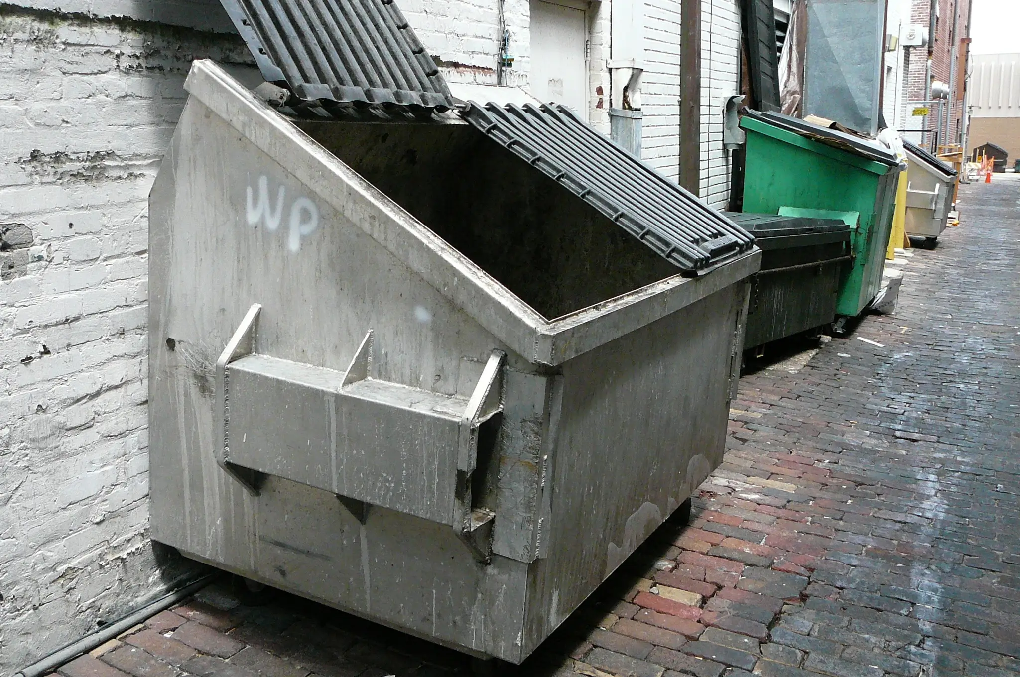 Commercial dumpsters have a flip-on, flip-off lid