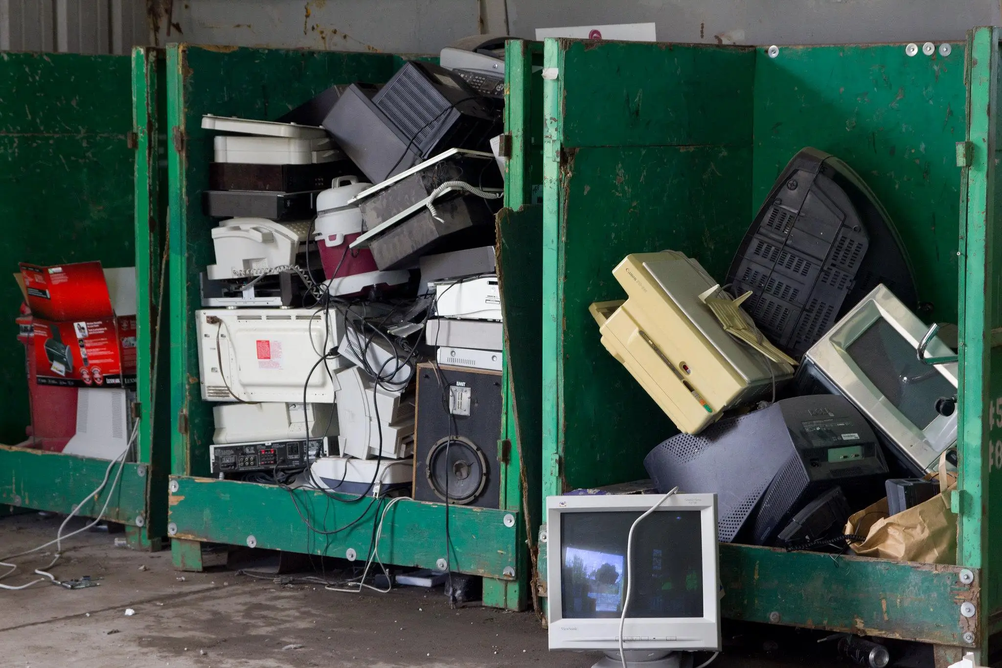 Old discarded electronics items, including computer monitors and speakers. E-waste can increase Delaware junk hauling prices, however free recycling is available