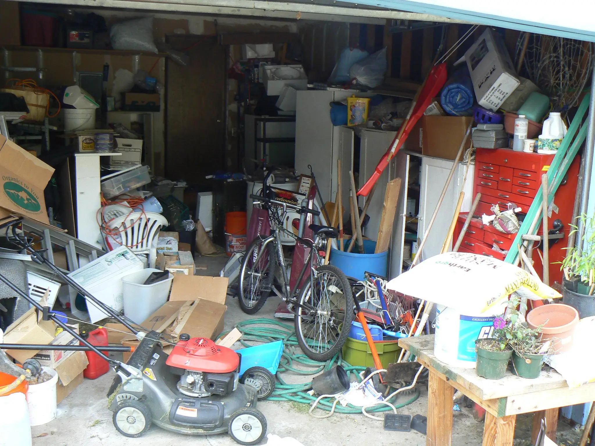 an image of a messy garage, highlighting the size and complexity of home junk removal jobs in Indiana.