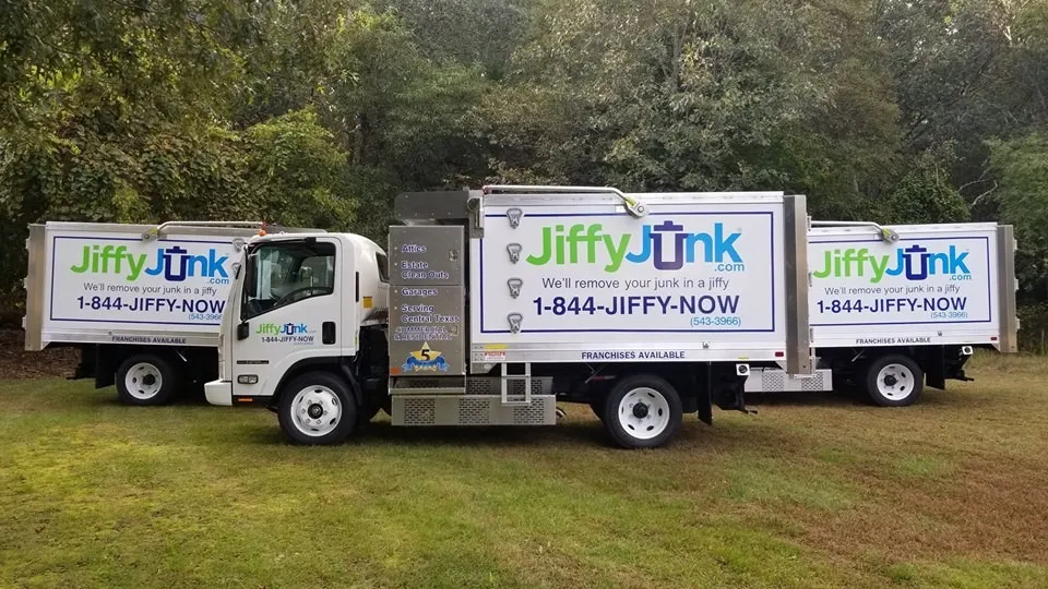 A photo showing three modern Jiffy Junk removal trucks. The best junk removal companies require high quality vehicles and equipment like this to complete their jobs.