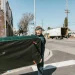 A junk removal worker carrying discarded furniture, opening our article comparing Jiffy Junk vs. JDog.