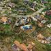 An aerial view of homes damaged by a hurricane.