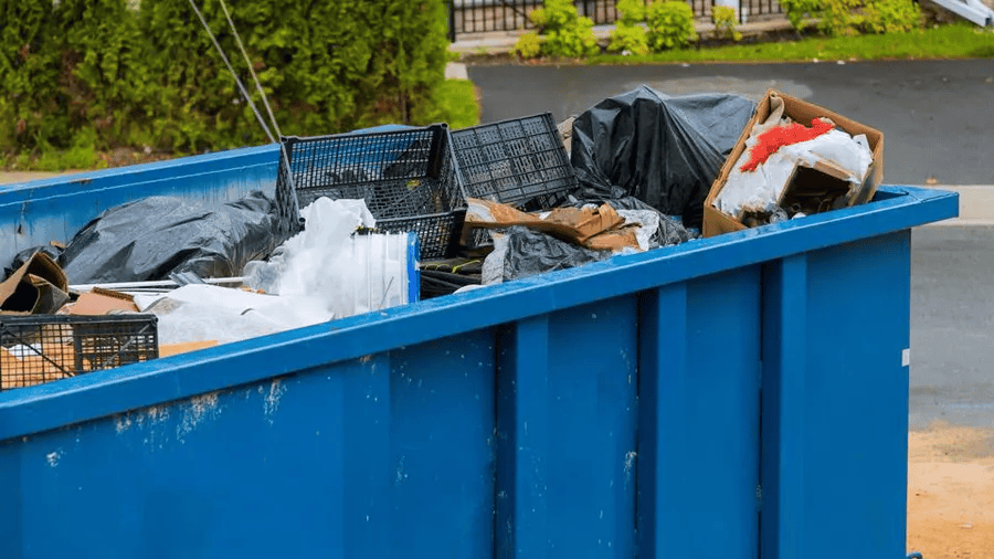 A dumpster showing junk hauling services.
