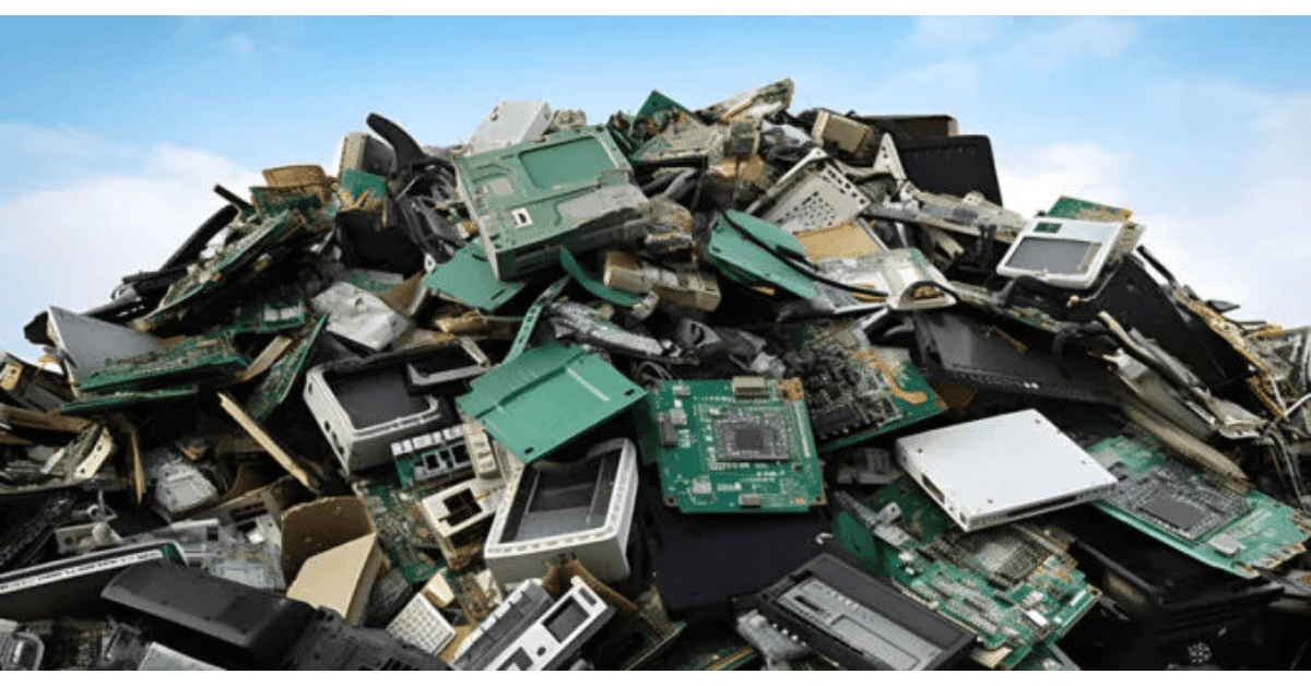 A large pile of e-waste (discarded electronic devices and circuit boards).